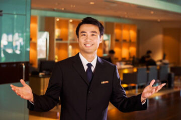 Chinese businessman in bar welcoming guests