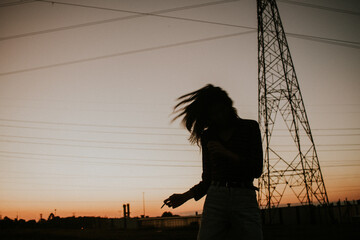Silhouette of woman standing during sunset