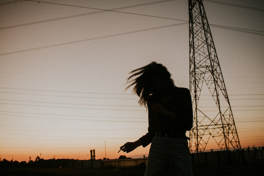 Silhouette of woman standing during sunset