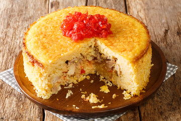 Tahchin or tah-chin, is an Iranian rice cake primarily consisting of rice, yogurt, saffron, and eggs stuffed with chicken fillets closeup in the plate on the table. horizontal
