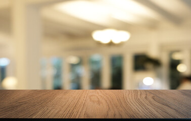 Empty wooden table in front of abstract blurred background of coffee shop . can be used for display or montage your products.Mock up for display of product