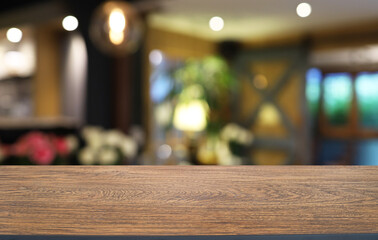 Empty wooden table in front of abstract blurred background of coffee shop . can be used for display or montage your products.Mock up for display of product