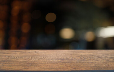 Empty wooden table in front of abstract blurred background of coffee shop . can be used for display or montage your products.Mock up for display of product