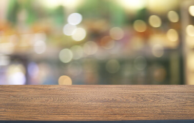 Empty wooden table in front of abstract blurred background of coffee shop . can be used for display or montage your products.Mock up for display of product