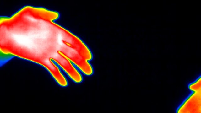 Thermal imaging camera Close-up of two colleagues shaking hands bump  handshake