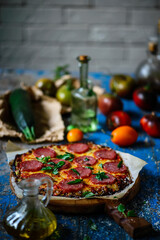 zucchini pizza crust with salami and cheese. Rustic style.