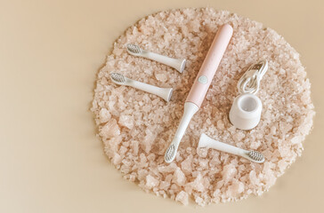 Ultrasonic toothbrush with replaceable heads and charging on sea salt crystals