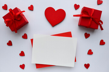 Valentine's day romantic composition. valentine's day background. red heart, figurines of white birds, gift box and place for text. red background. congratulation. invitation
