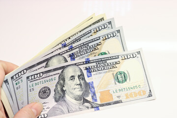 Currency American dollars in hand - paper banknotes. Money background.