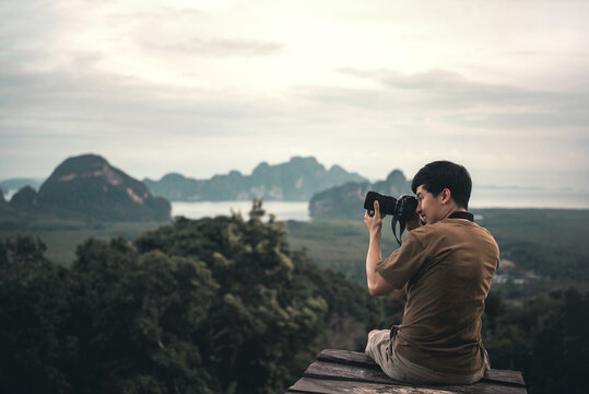 Man traveler take photo view of mountain with dslr camera.