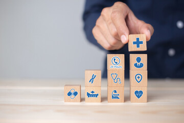 Hand arranging wood block stacking with icon healthcare medical, Health insurance - concept.