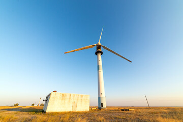 Old abandoned wind turbines in the desert landscape