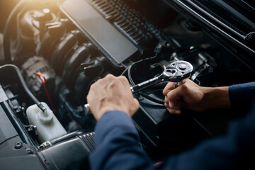 Fototapeta na wymiar Car service, repair, maintenance concept. Auto mechanic working in garage.