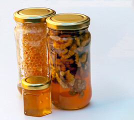 Honey with nuts surrounded by white background