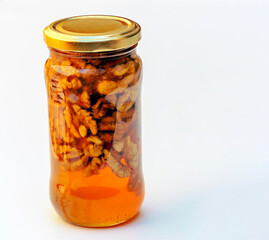Honey with nuts surrounded by white background