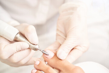 Pedicure nail spa procedure. Foot manicure. Salon master. Polish woman leg. Hands in gloves. Light background. Master equipment. Healthy toe cleaning. Pink pastel color. Dermatology