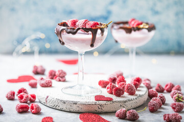 Red Valentine's day cocktail in a glass. Beverage with raspberry