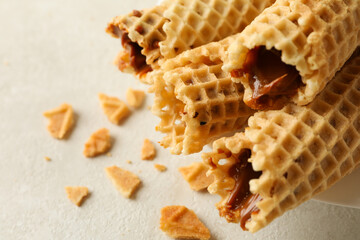 Tasty wafer rolls with condensed milk, close up
