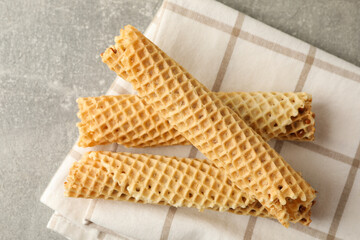 Napkin with wafer rolls with condensed milk on gray background