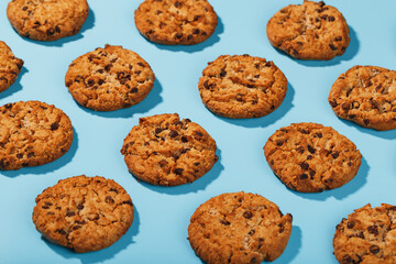 Oatmeal cookies with chocolate chip pattern and patterns on a light blue background.