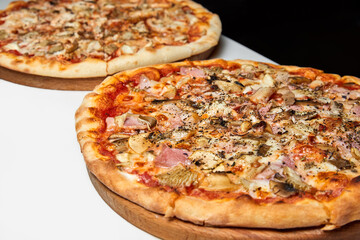 Fresh pizza with bacon, mushrooms and cheese on a light background. Close-up, selective focus
