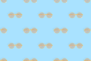Glasses seamless pattern. Glasses for improving vision on a blue background.