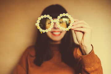 Happy, optimistic and laughing woman with flower sunglasses expresses joie de vivre and positive...