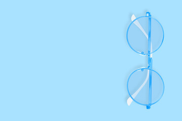 Glasses for improving vision on a blue background.