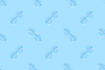 Glasses seamless pattern. Glasses for improving vision on a blue background.