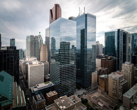 Two glass paneled high rise building under grey cloudy sky