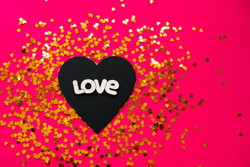 Black heart with the words love on a red background put on Valentine's Day