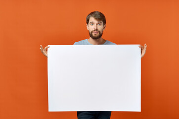 white sheet of paper ad advertisement man in the background orange background mockup poster