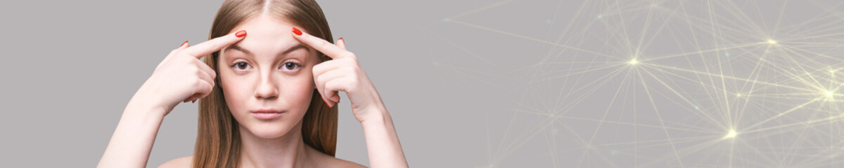 Obraz premium Facial spa treatment. Dermatology spa mask. Detox therapy. Rejuvenation skincare beauty. Girl finger point on face. Health cosmetology concept. Grey net background. Copyspace, banner. Forehead