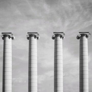 Grayscale photo of four white pillars
