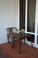 Interior building design and decoration of terrace patio decorated with mirror glass frame, indoor green plants and wooden antique furniture
