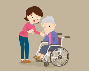 Woman soothes a grieving grandmother sitting on a wheelchair