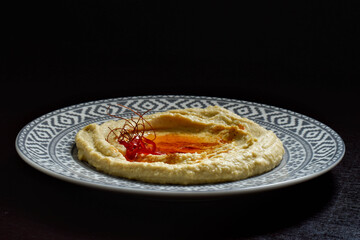 Plate with hummus, olive oil and chili