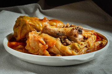 Pork ribs in cabbage leaf with tomato sauce