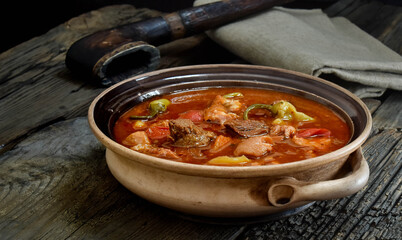 Traditional Hungarian goulash soup with stew and paprika.  Prepared in a cauldron over a fire.  Bograch.