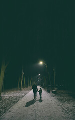 Mother and son are walking in the winter forest