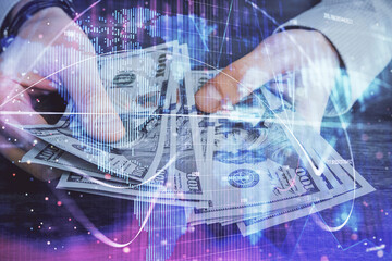 Multi exposure of financial theme drawing hologram and USA dollars bills and man hands. Business concept.