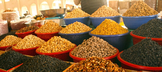 Uzbek bazaar. Sweets, nuts and dry fruits on the market in old Bukhara town, Uzbekistan. Banner size