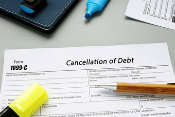Business concept meaning Form 1099-C Cancellation of Debt with sign on the page.