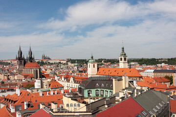 Naklejka na ściany i meble Tynsky and St Vitus cathedral among the red roofs of Prague. View from above