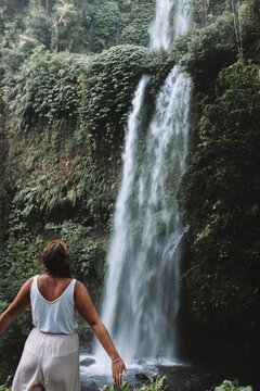 Woman standing near waterfall