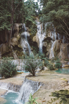 Water falls on brown rocky mountain