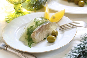 Jellied sturgeon with lemon, olives and glasses of white wine