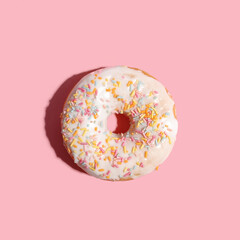 appetizing fresh doughnut on a pink background