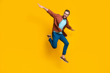 Fototapeta na wymiar Full length body size photo of male student playful cheerful student laughing isolated on bright yellow color background