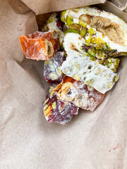Rahat lakoum in paper bag. Traditional turkish dessert. Sweet snack food. Vertical mobile traveling photo